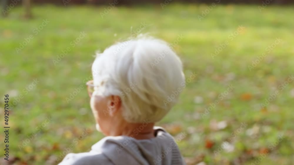 Happy retired Caucasian couple enjoying their time in park laughing holding hands jumping closeup . High quality 4k footage Happy retired Caucasian couple enjoying their time in park laughing holding hands jumping closeup . High quality 4k footage