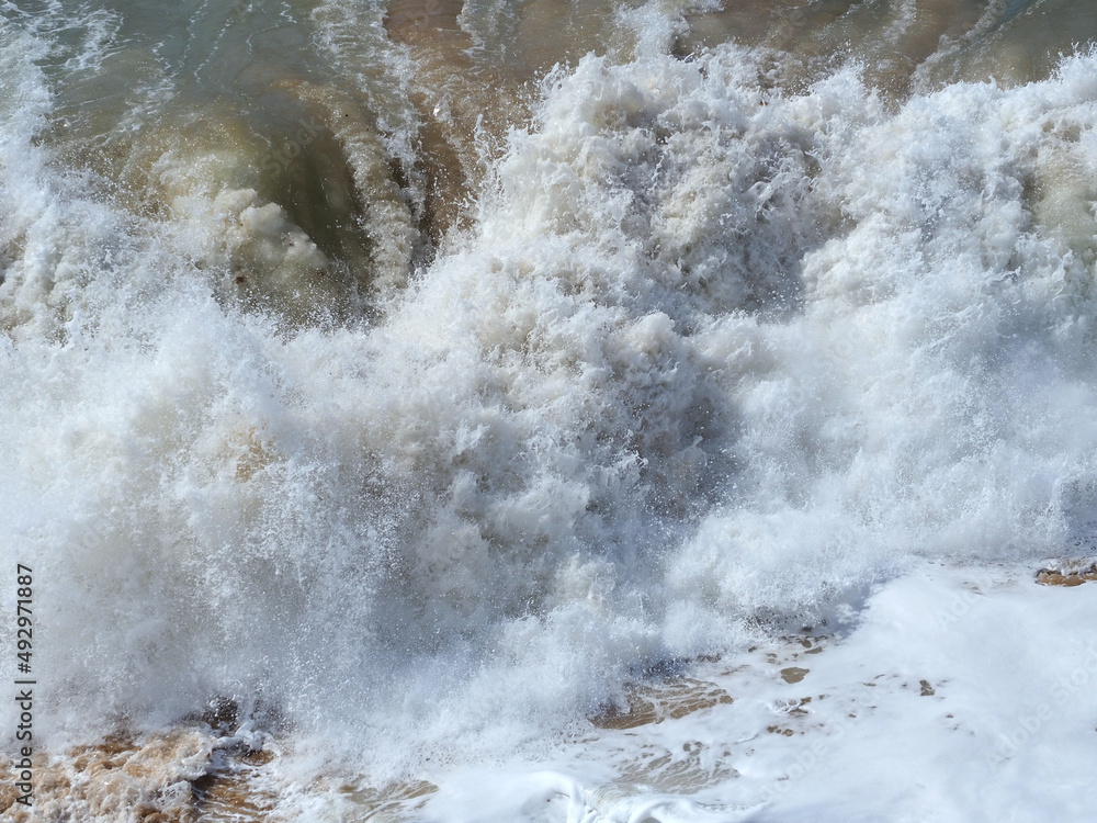 Obraz premium Beautiful foamy sea waves in bad weather.A storm at sea.