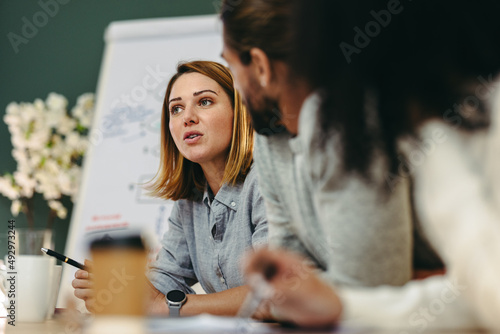 Young businesswoman having a discussion with her colleagues in a meeting