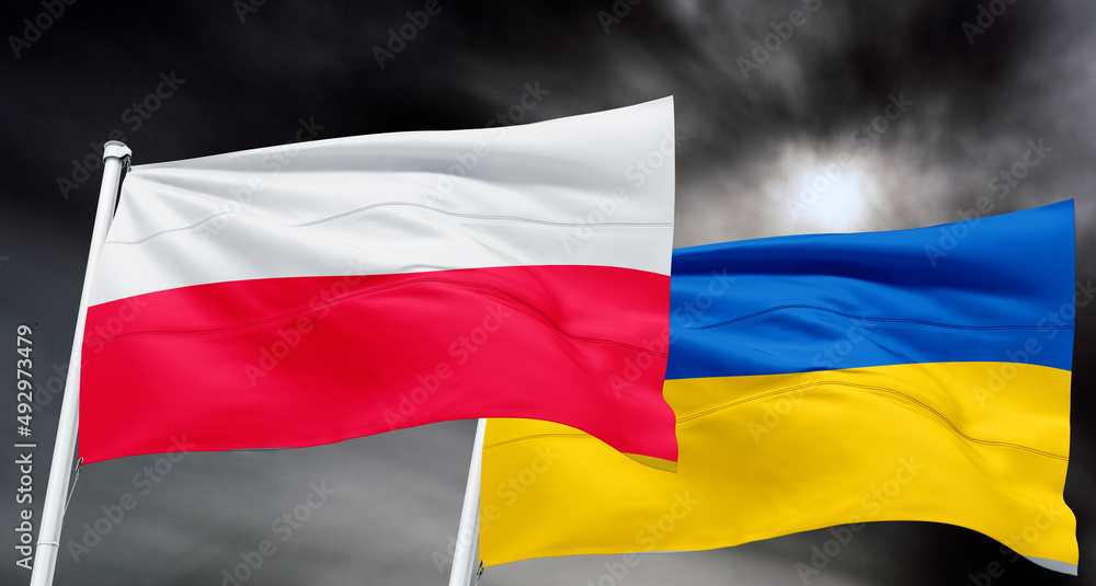 crossed national flags of Ukraine and poland flag waving in wind at ...