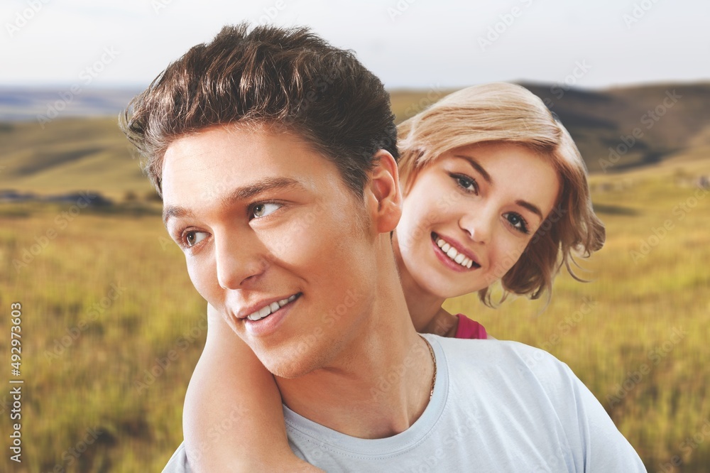 Happy couple holding hands and walking through wheat field while looking away. Nature landscape. Happy couple holding hands and walking through wheat field while looking away. Nature landscape.