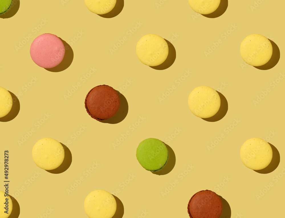 Pattern Macaron cookies on a yellow background Pattern Macaron cookies on a yellow background