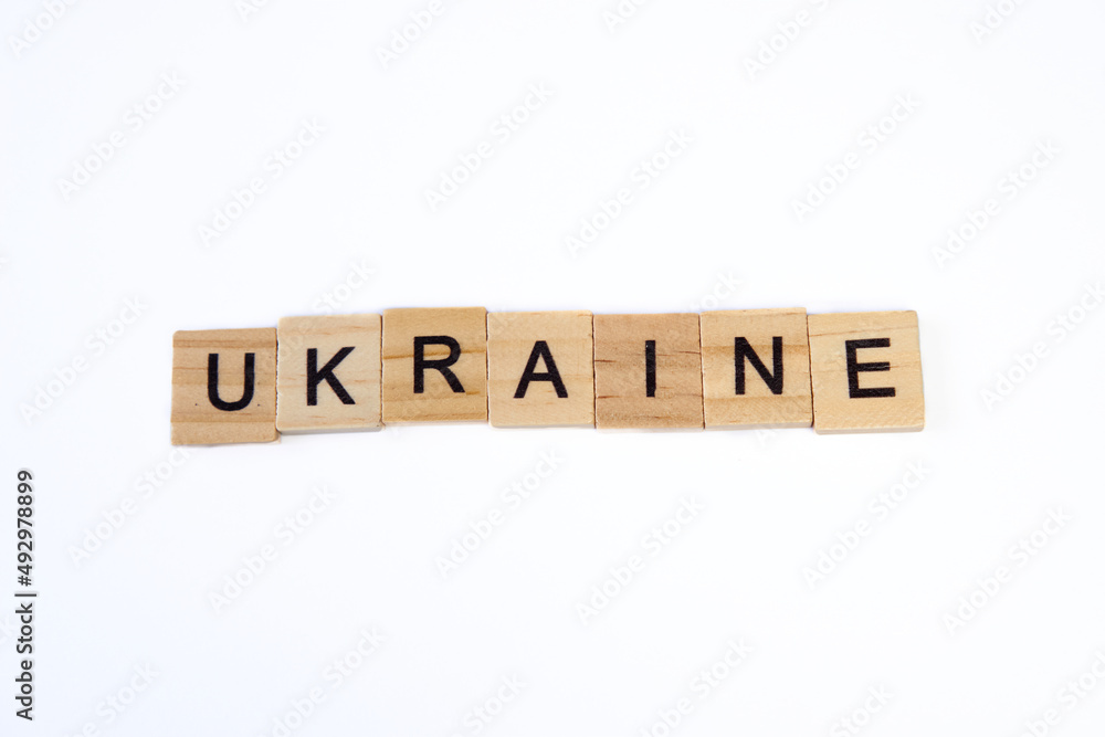 Top view of word ukraine is laid out of wooden squares isolated on white background. Concept of peace, war in Ukraine,support,no war Top view of word ukraine is laid out of wooden squares isolated on white background. Concept of peace, war in Ukraine,support,no war