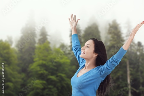 Overjoyed happy woman enjoying the green beautiful nature, healthy natural lifestyle