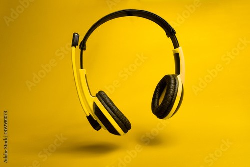 yellow headphones on yellow background 