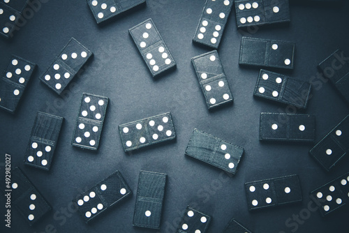 Black dominoes on dark table background