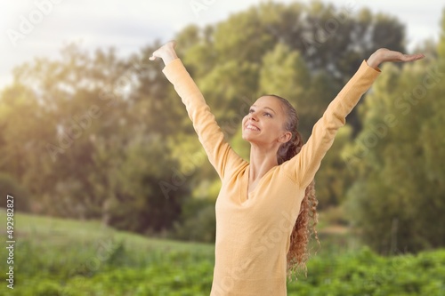 Overjoyed happy woman enjoying the green beautiful nature, healthy natural lifestyle