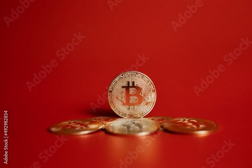 gold bitcoin coins on red background 