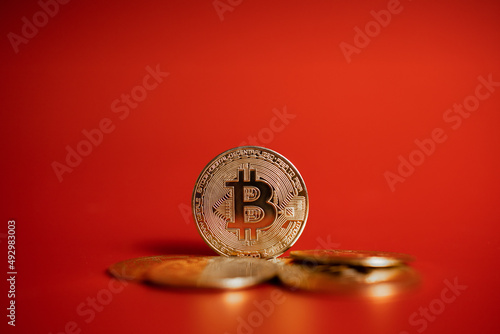 gold bitcoin coins on red background 
