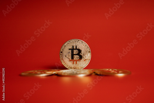 gold bitcoin coins on red background 
