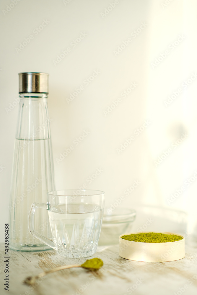 Green herbal detox powder in a plate on wooden table. Superfood. Organic eco health care. Vitamin nutrition and treatment. Immune system support. Alternative medicine. Dietary supplement, bowel clean. Green herbal detox powder in a plate on wooden table. Superfood. Organic eco health care. Vitamin nutrition and treatment. Immune system support. Alternative medicine. Dietary supplement, bowel clean.