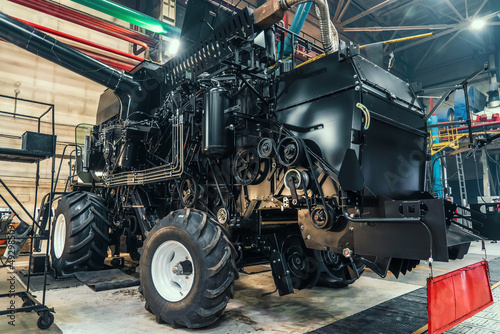 Initial adjustment of agricultural tractor or combine harvester in industrial machinery factory. Test and run-in of wheels on special stand.