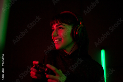 Female Gen Z gamer using a video game console