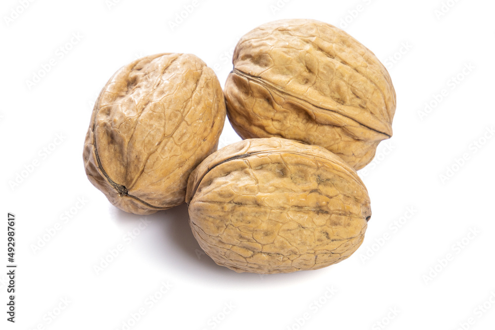 whole fresh walnuts on a white background whole fresh walnuts on a white background