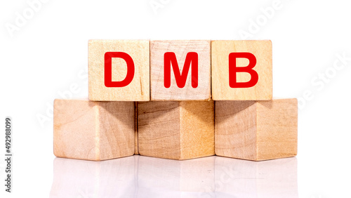 DMB text on wooden cubes on a white background
