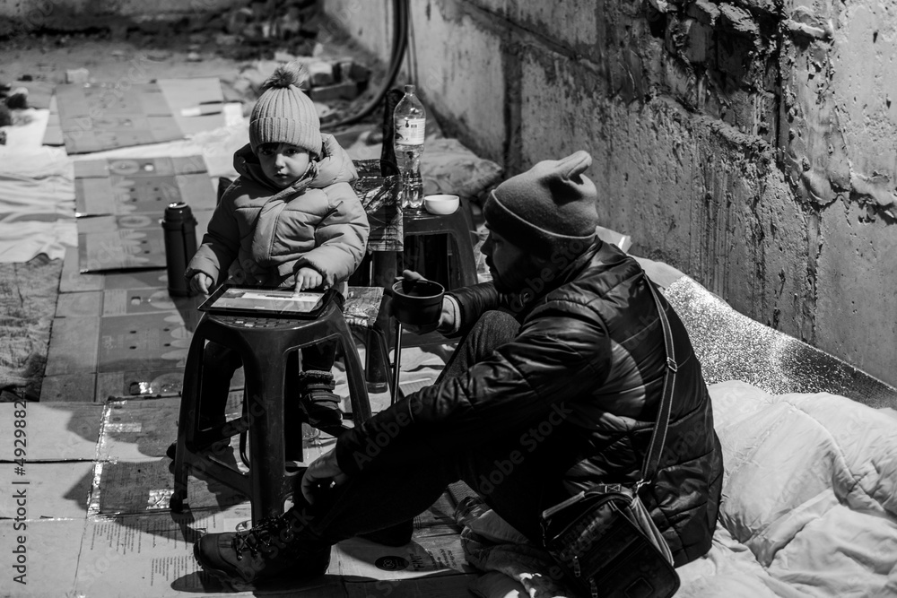 Fototapeta premium War in Ukraine. The family is in a bomb shelter.