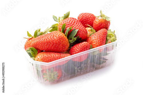 Принти на полотні whole red strawberries in a plastic tray on a white background