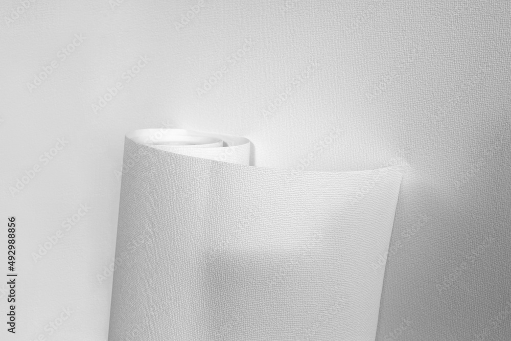 Rolled sheet of white textured wallpaper, on white background. Wallpaper Rolls Mockup Rolled sheet of white textured wallpaper, on white background. Wallpaper Rolls Mockup