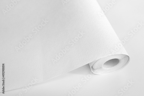 Rolled sheet of white textured wallpaper, on white background. Wallpaper Rolls Mockup
