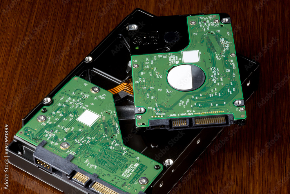 Computer Hard Drives on a Wooden Table Top Computer Hard Drives on a Wooden Table Top