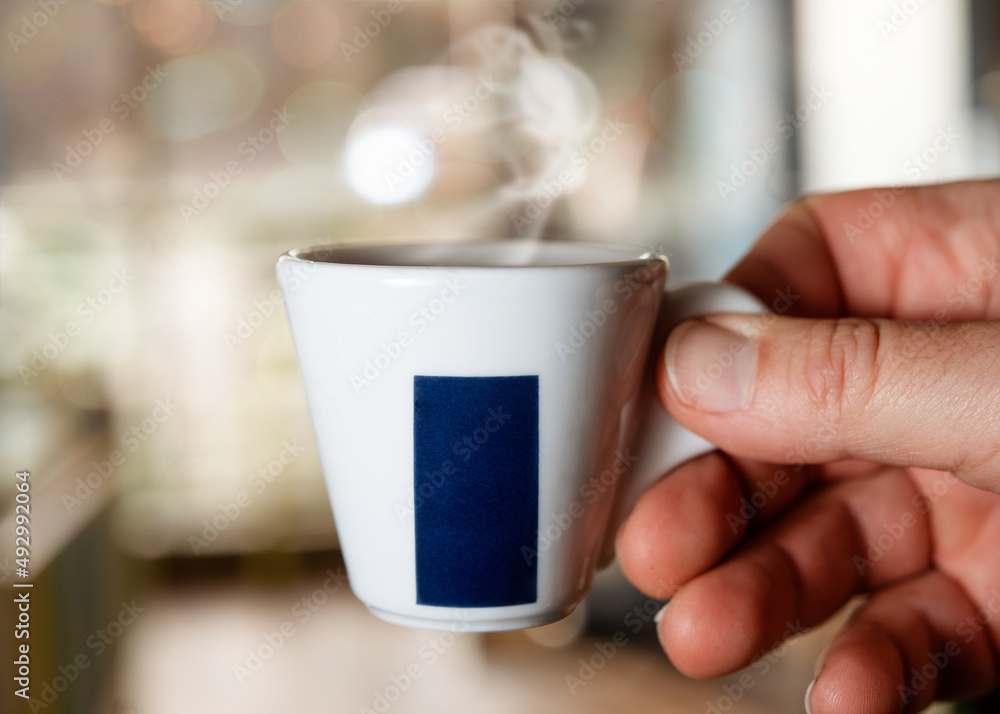 hands holding cup of coffee in the cafe hands holding cup of coffee in the cafe
