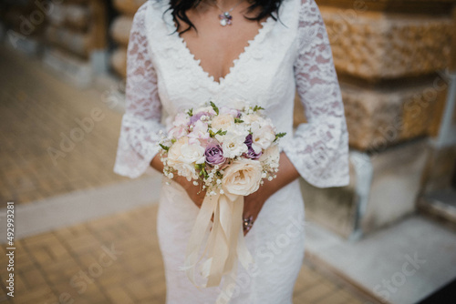 Bride holding a wedding bouquet. Rustic wedding bouquet.