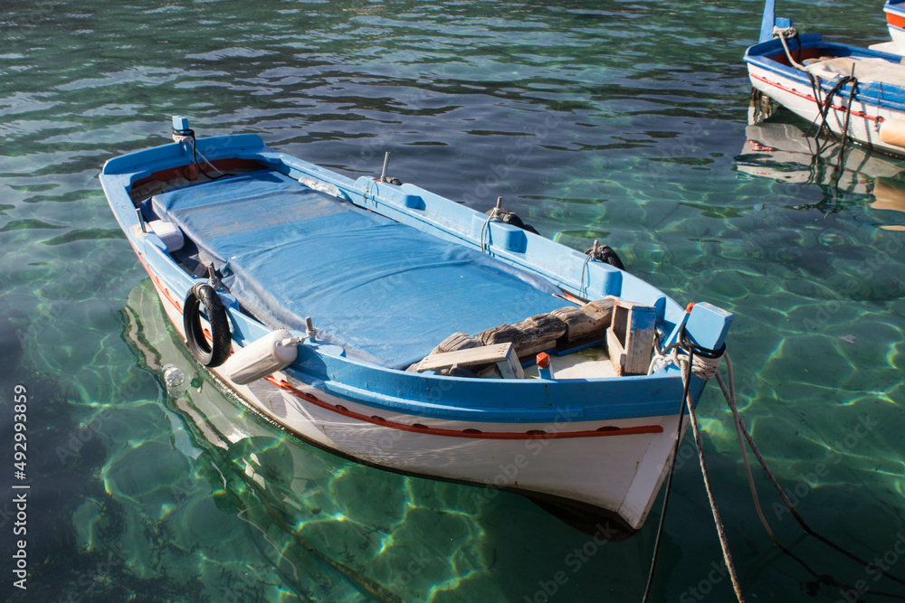 evocative image of fishing boats moored in the harbor in a small fishing village in Sicily, Italy
