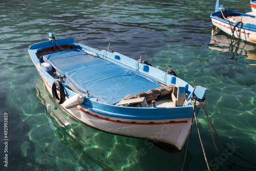evocative image of fishing boats moored in the harbor in a small fishing village in Sicily, Italy  © massimo