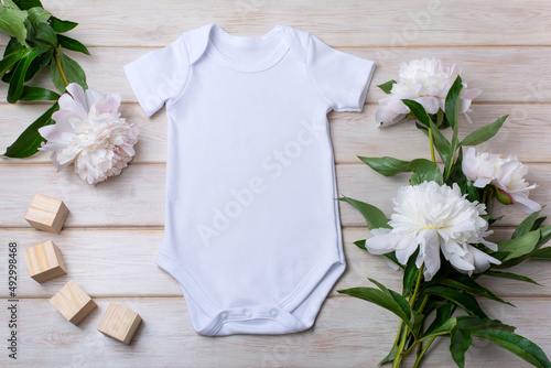 White baby short sleeve bodysuit mockup with peony and toy blocks