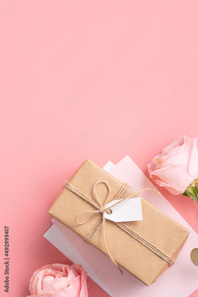 Mother's Day design concept background with pink rose flower and gift on pink background.