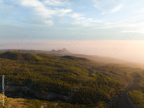 Aerial of a mountain range at sunset in Tenerife Spain, nature island, trees hills rocks, cliffs and mountains at golden hour. Europe