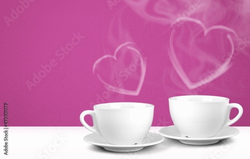 Mockup white coffee with two cups or mugs on a background. Hot drink steam in the form of hearts