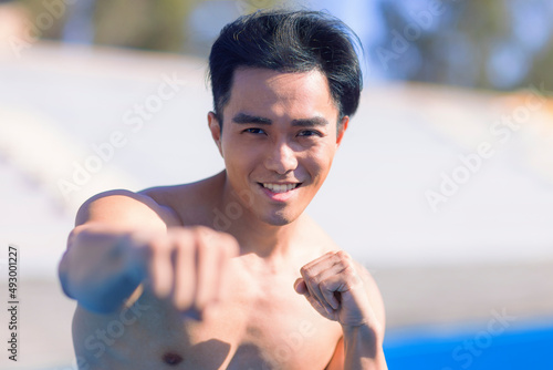 Young fit man doing boxing exercises