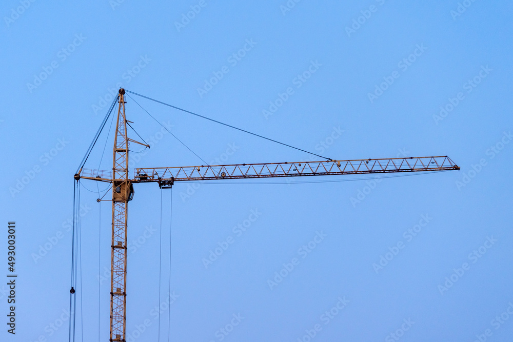 A construction crane on a blue sky background. Copy Space A construction crane on a blue sky background. Copy Space