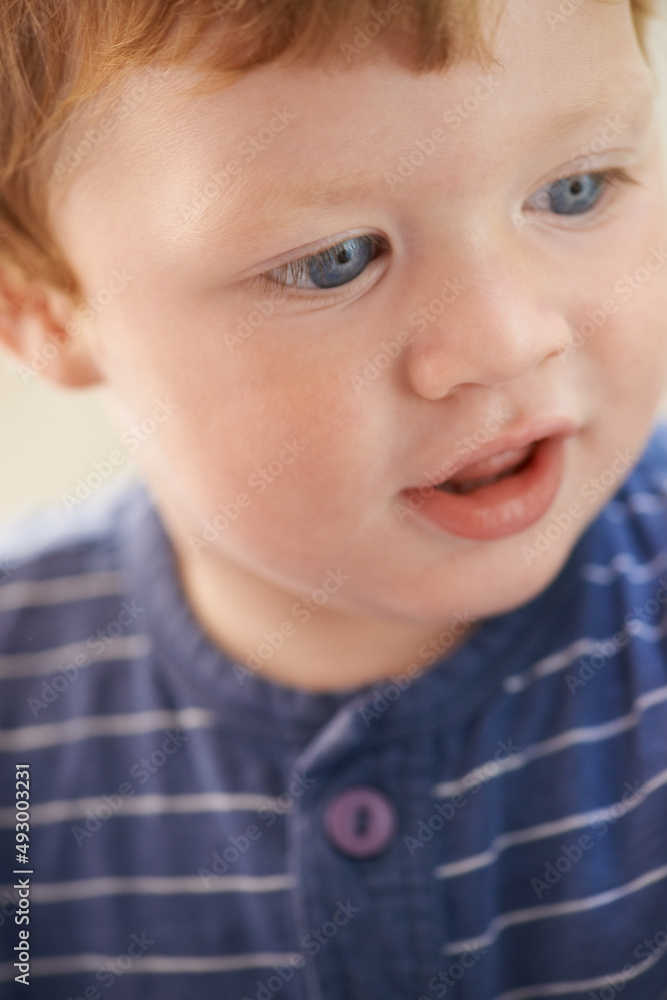 Filled with innocence. Cropped view of a cute red-headed toddler. Filled with innocence. Cropped view of a cute red-headed toddler.