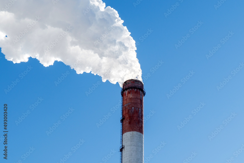 Factory pipes thermal power plants with thick white smoke from heat energy nuclear plant polluting environment. Copy space