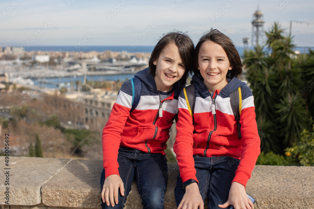 Obraz premium Cute little children tourists admiring Barcelona city, family travel with kids