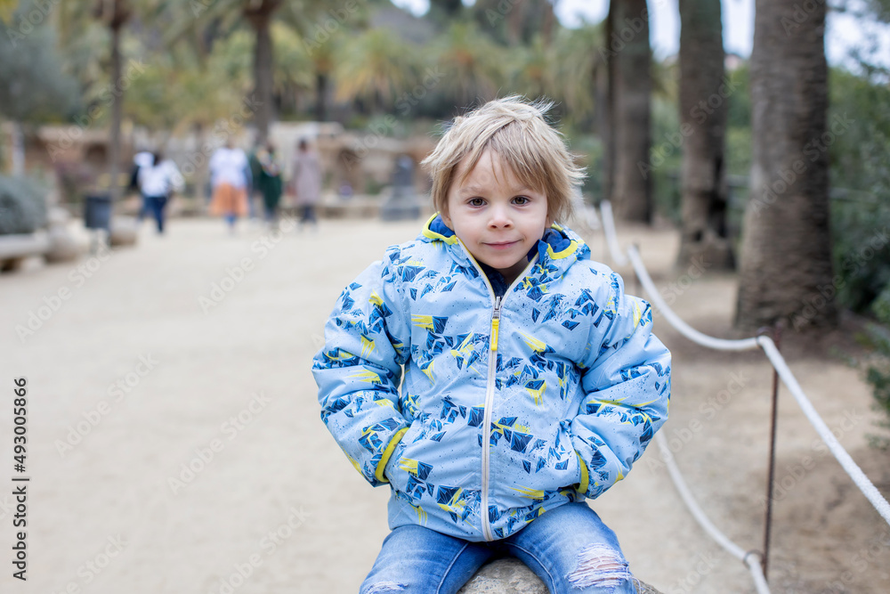 Child, cute toddler blond boy, posing in park Guell in Barcelona Child, cute toddler blond boy, posing in park Guell in Barcelona