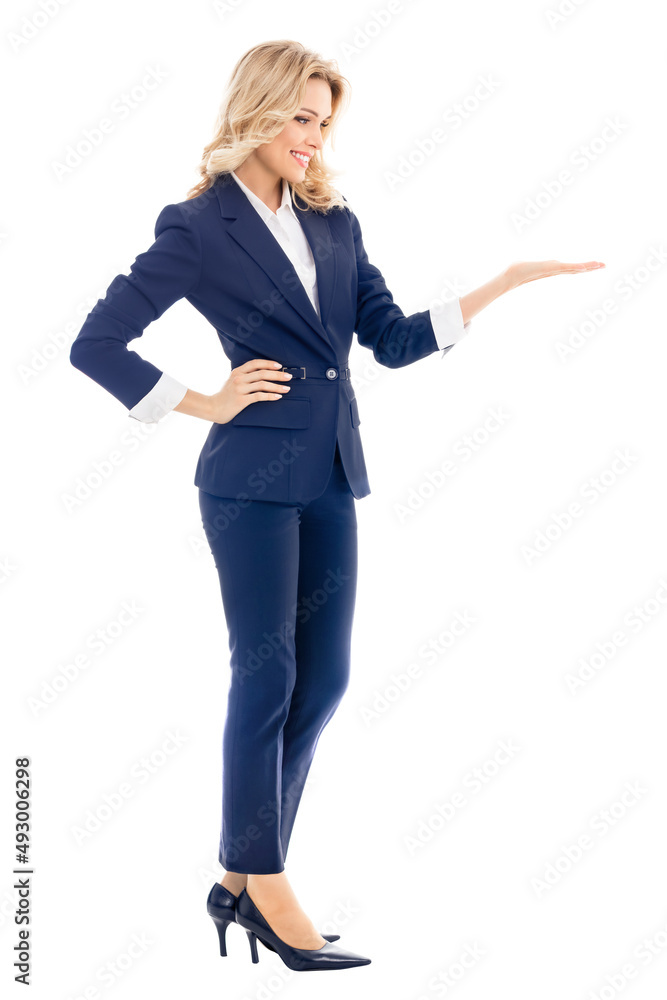 Full body of smiling businesswoman in confident blue suit, showing, giving or holding some product or copy space for text, isolated over white background. Full body of smiling businesswoman in confident blue suit, showing, giving or holding some product or copy space for text, isolated over white background.