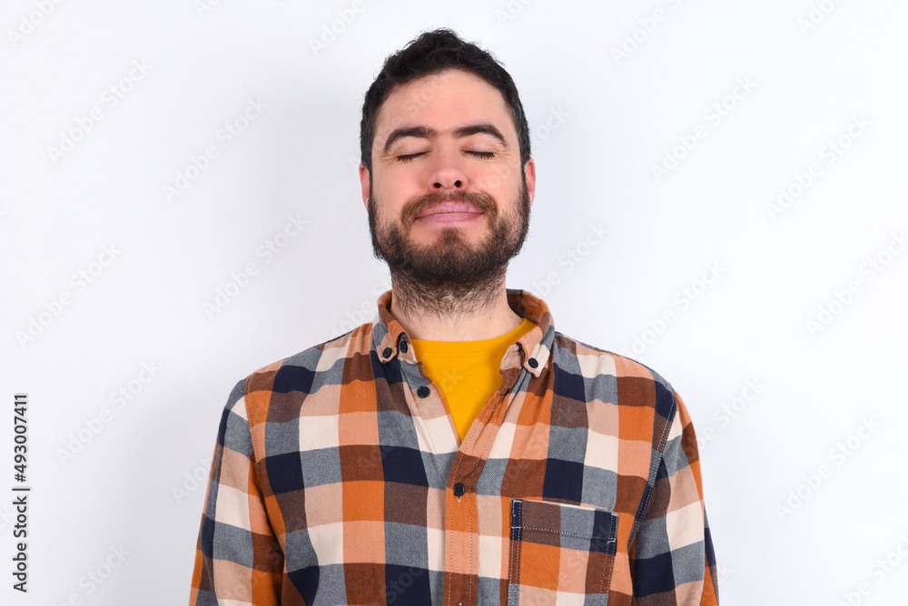young caucasian man wearing plaid shirt over white background nice-looking sweet charming cute attractive lovely winsome sweet peaceful closed eyes young caucasian man wearing plaid shirt over white background nice-looking sweet charming cute attractive lovely winsome sweet peaceful closed eyes
