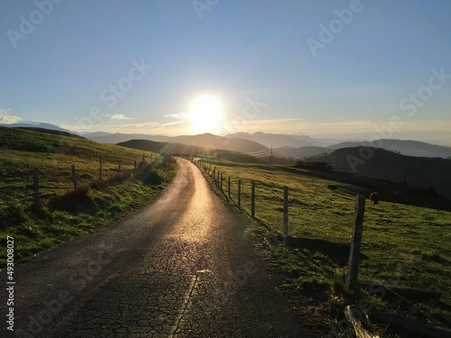 The setting sun at the end of a mountain trail
