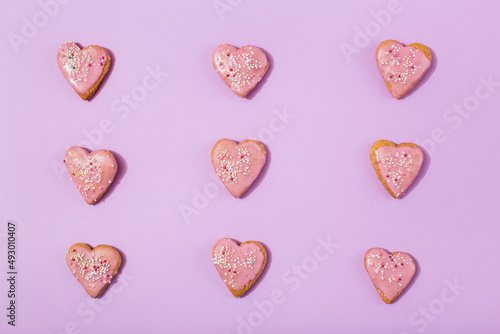 Tasty heart shaped cookies on pink background