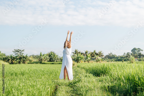 Pregnant woman going at the field with green grass and dance with happy face. Sunshine summer vibes