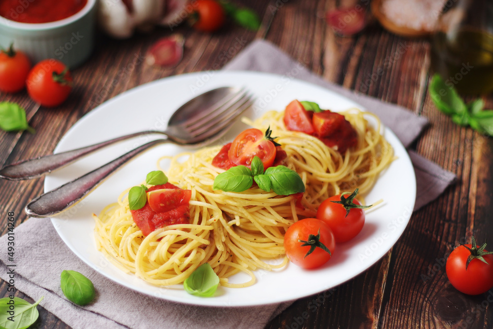 Italian pasta spaghetti with basil and cherry tomatoes Italian pasta spaghetti with basil and cherry tomatoes