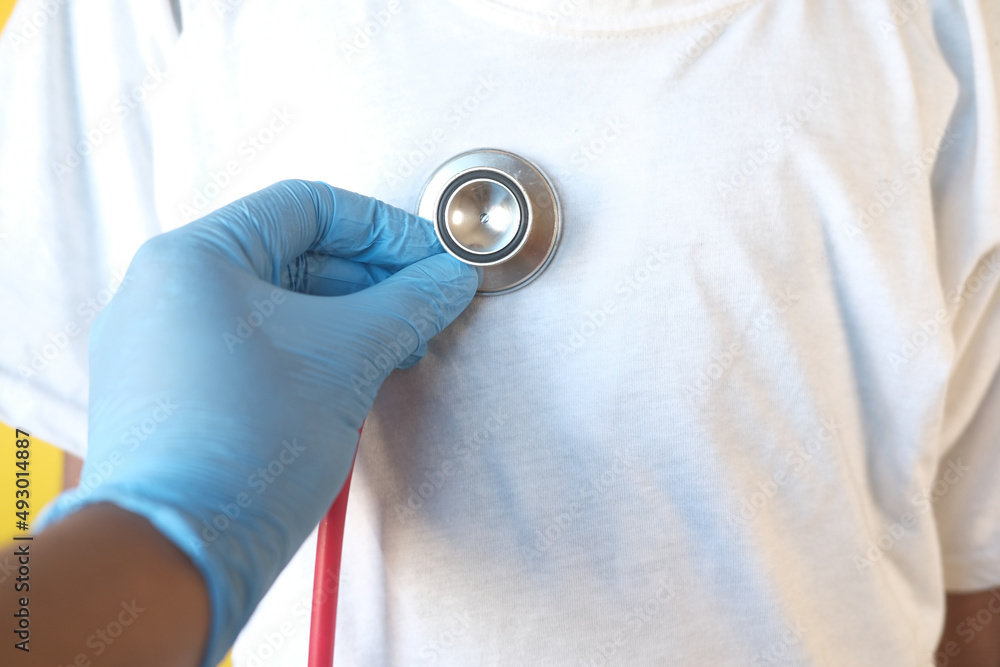 Fototapeta premium Doctor using a stethoscope checking child body, close up