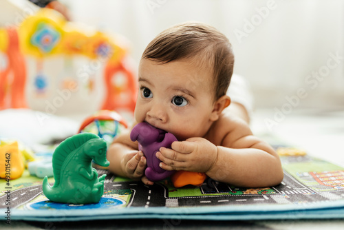 Baby playing with toys on the floor.
