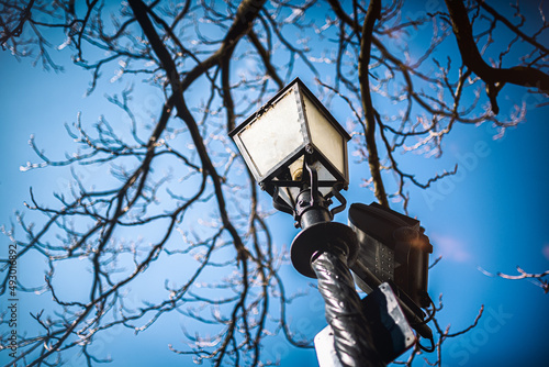 Typical street lamp design in Budapest - Hungary, blurred blue  background