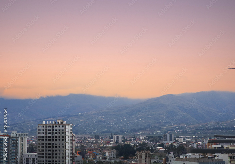 view of the city and mountains at sunset.