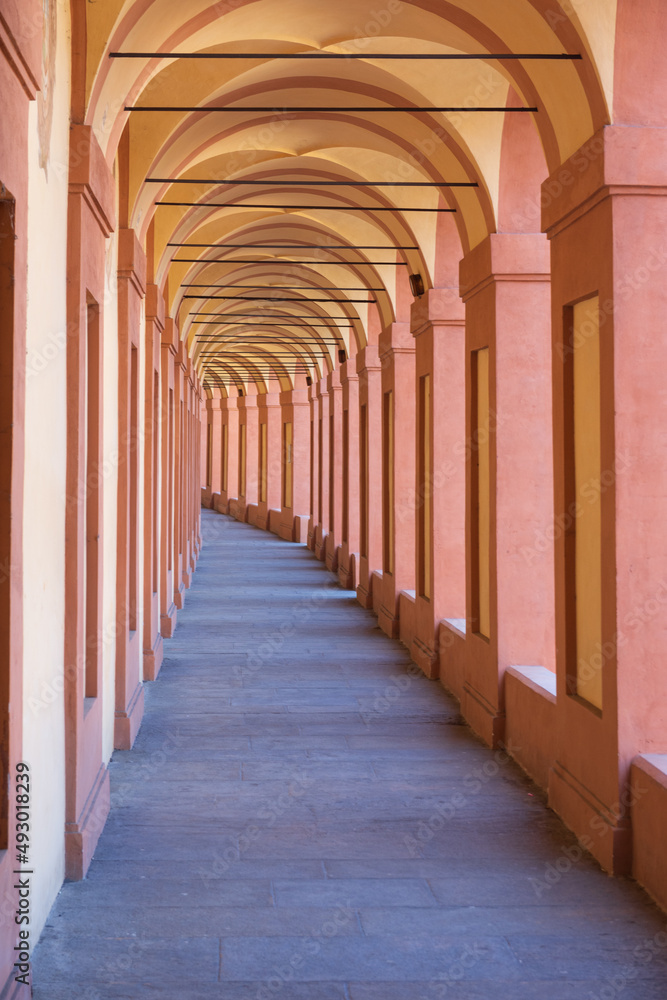 Beautiful streets of Bologna in the morning, arcaded streets with columns