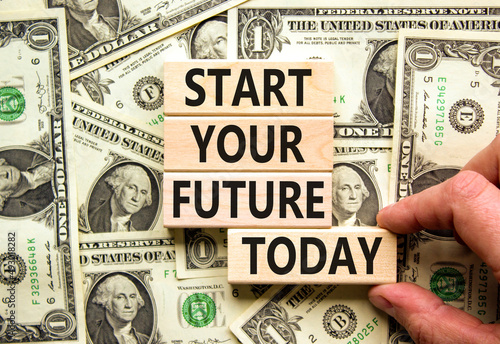 Start your future today symbol. Concept words Start your future today on blocks. Businessman hand. Beautiful background from dollar bills. Start your future today business concept. Copy space.